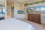 As you are embraced by wrap-around windows, bask in the awe-inspiring vistas of Molokai right from the comfort of your own bed